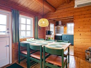 a kitchen with a table and chairs in a room at 4 person holiday home in Assens in Assens