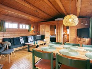 a dining room with a table and chairs and a television at 4 person holiday home in Assens in Assens +16 photos