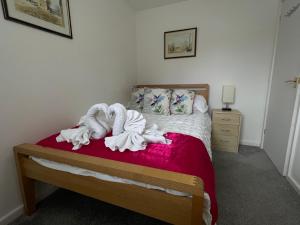 a bedroom with a bed with towels on it at Riverside 2 Bedroom Townhouse with Car Charger in Abergavenny