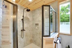 a shower with a glass door in a bathroom at 3 Acres of Luxury and Views in Fred Wine Country! in Luckenbach +27 photos