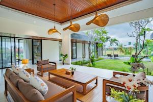 an open living room with a couch and a table at 4BR Rice Fields view & Spa Villa Abian in Sukawati