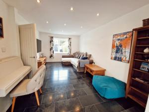 a living room with a couch and a table at 5 star Luxury Home in a Magnificent area -Chester in Hough Green +30 photos