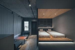 a bedroom with a bed and a couch in it at SEKAI HOTEL Deep Osaka Experience in Osaka +47 photos