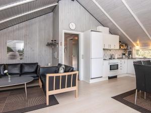 a living room with a couch and a table and a kitchen at Secluded Retreat in Nature - By Traum Ferienwohnungen in Blåvand