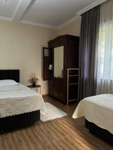 a bedroom with two beds and a large window at Marinas Guesthouse in K'obulet'i