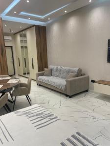 a lobby with a couch and a table and chairs at Sea breeze, studio apartment in Nardaran