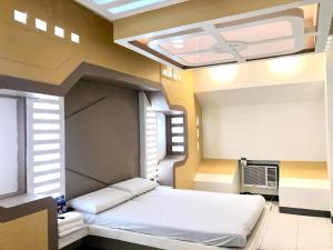 a room with a bed in a room with a window at Astrotel Cebu in Cebu City
