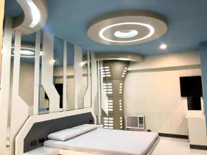 a room with a ceiling with a bed in it at Astrotel Cebu in Cebu City