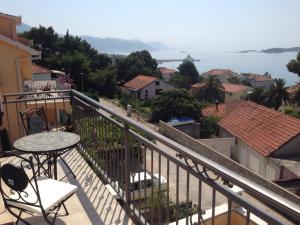 a balcony with a table and a view of the water at Apartments Sabioncello in Orebić