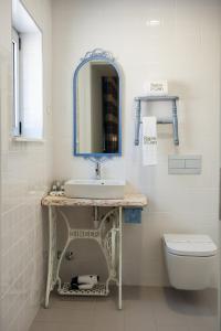 a bathroom with a sink and a toilet at Casa da Ribeira do Círio in Seia +36 photos