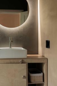a bathroom with a sink and a mirror at Getlost cabins in Valanciunai