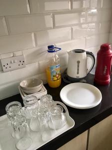 een aanrecht met glazen, een bord en een kan bij Sweethaven in Nairobi +53 foto's