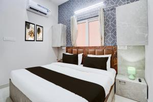 a bedroom with a large bed in a room at Super Townhouse Vasundra Nagar Formerly Joystel in Jaipur