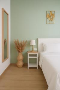 a bedroom with a bed and a table with a lamp at Alice al Mare in Pescara