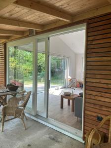an open living room with sliding glass doors at Naturhaus am Weiher in Hülsen