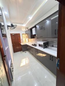 a large kitchen with a stove and a counter top at 3 bed Designer House in Islamabad