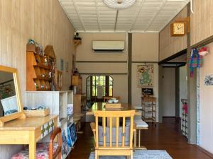 a room with a table and chairs in a room at 月光寶盒旅店 Moonlight Hostel in Kaohsiung