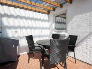 a table and chairs on a patio with a window at 4 star holiday home in Gråsten in Gråsten