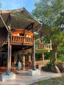 a large wooden house with a large deck at Baan Nara Homestay - Koh Kood in Ko Kood