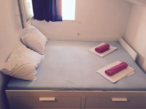a small bed with two pillows on top of it at Apartment Maria in Neum