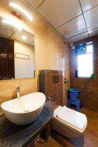 a bathroom with a sink and a toilet at RedRock Villa in Mahabaleshwar +25 photos