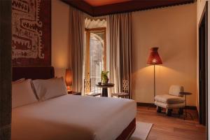 a hotel room with a bed and a window at Palacio De Godoy Caceres, Curio Collection By Hilton in Cáceres +45 photos