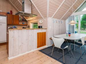 a kitchen with a table and chairs in a room at Eco-Friendly Retreat with Spa - By Traum Ferienwohnungen in Blåvand +19 photos