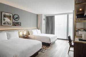 a hotel room with two beds and a large window at Hilton Arlington Rosslyn The Key in Arlington +46 photos