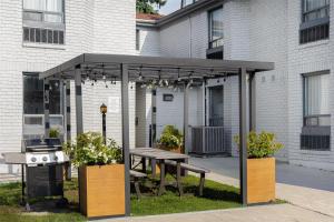 a pavilion with a picnic table and a grill at Spark by Hilton Brockville in Brockville
