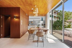 a kitchen and dining room with a table and chairs at Hotel Casarose - Cannes Mandelieu in Mandelieu-La Napoule