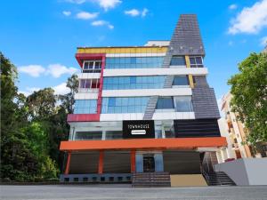 a building with a pyramid on top of it at Super Townhouse Ramamurthy Nagar West Formerly Phoenix Hotel in Bangalore