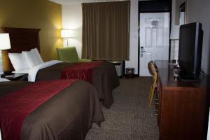 a hotel room with two beds and a flat screen tv at Grand Vista Hotel in Huntsville