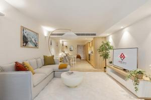 a living room with a couch and a table at Pacific Chic Luxury Pad 2 - Beachfront Aircon Lift in Sydney