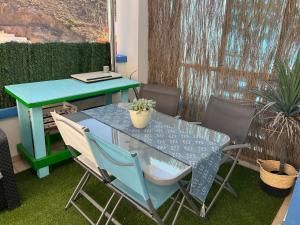 a table and chairs on a patio with a table at Salamandra in Carboneras