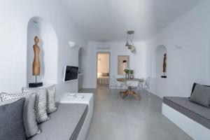a white living room with a couch and a table at Sensation Villa - by Senses Collection in Pyrgos