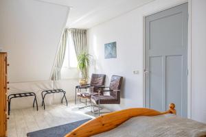 LauwerzijlにあるBed en breakfast Uitrustのベッドとテーブルと椅子のある寝室 +93枚の写真