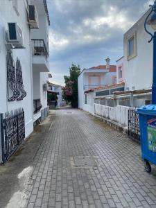 an empty street in a town with white buildings at Ground floor Apartment with Garden in Polykhrono