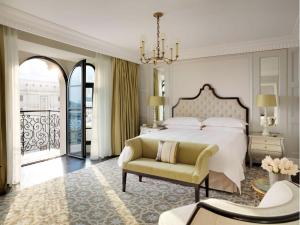 a bedroom with a bed and a couch and a chair at Four Seasons Hotel Baku in Baku