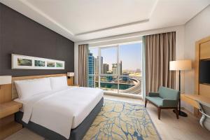 a hotel room with a bed and a large window at DoubleTree by Hilton Dubai Jumeirah Beach in Dubai