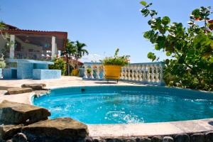 a swimming pool in a yard with a fence at Hillhouse in Río San Juan