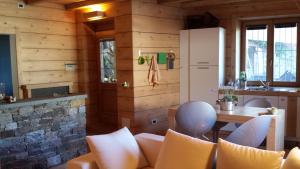a kitchen with wooden walls and a table and chairs at Appartamento Le Chalet in Albosaggia