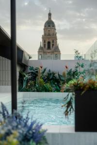 a view of a building with a clock tower in the background at Los 36 by GRUPO CCOMMO in Murcia