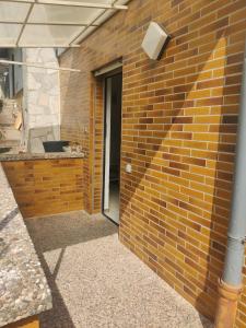 a brick wall with a door and a building at 64747 Breuberg Odenwald 2 Schlafzimmer in Breuberg