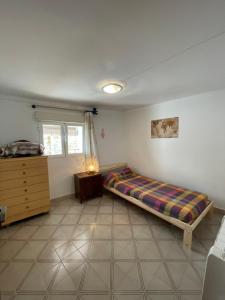 a bedroom with a bed and a dresser in it at Casa de Pueblo in Sarratella