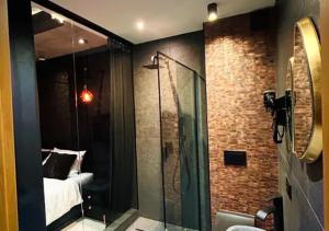 a bathroom with a shower and a bed in a room at Schronisko Zmysłów - Apartament 6 in Kościelisko +12 photos