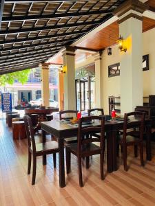 a dining room with a table and some chairs at Maison Vongprachan Legend in Luang Prabang +33 photos