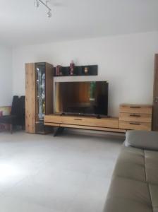 a living room with a couch and a flat screen tv at Attraktive Neubauwohnung in Bremen