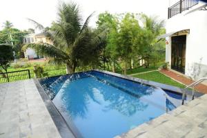a swimming pool in front of a house at Tranquile Viwe in Gonapinuwala West