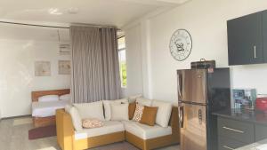 a living room with a couch and a refrigerator at Tranquile Viwe in Gonapinuwala West