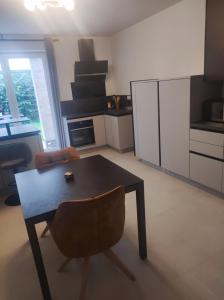 a kitchen with a table and a chair in a room at Attraktive Neubauwohnung in Bremen